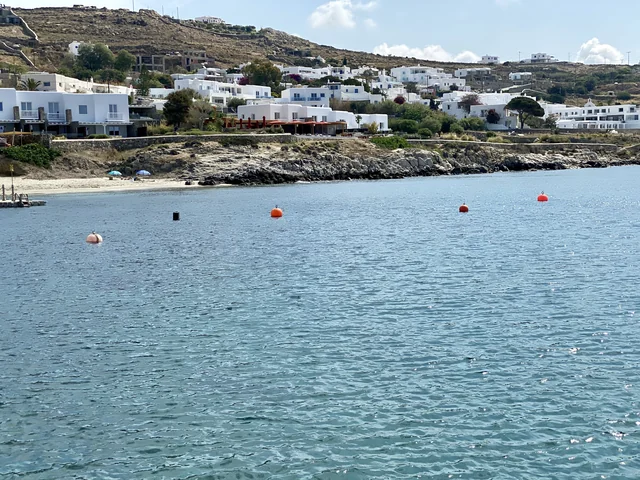 White buildings and the shoreline at Agios Ioannis, Mykonos, in May 2023